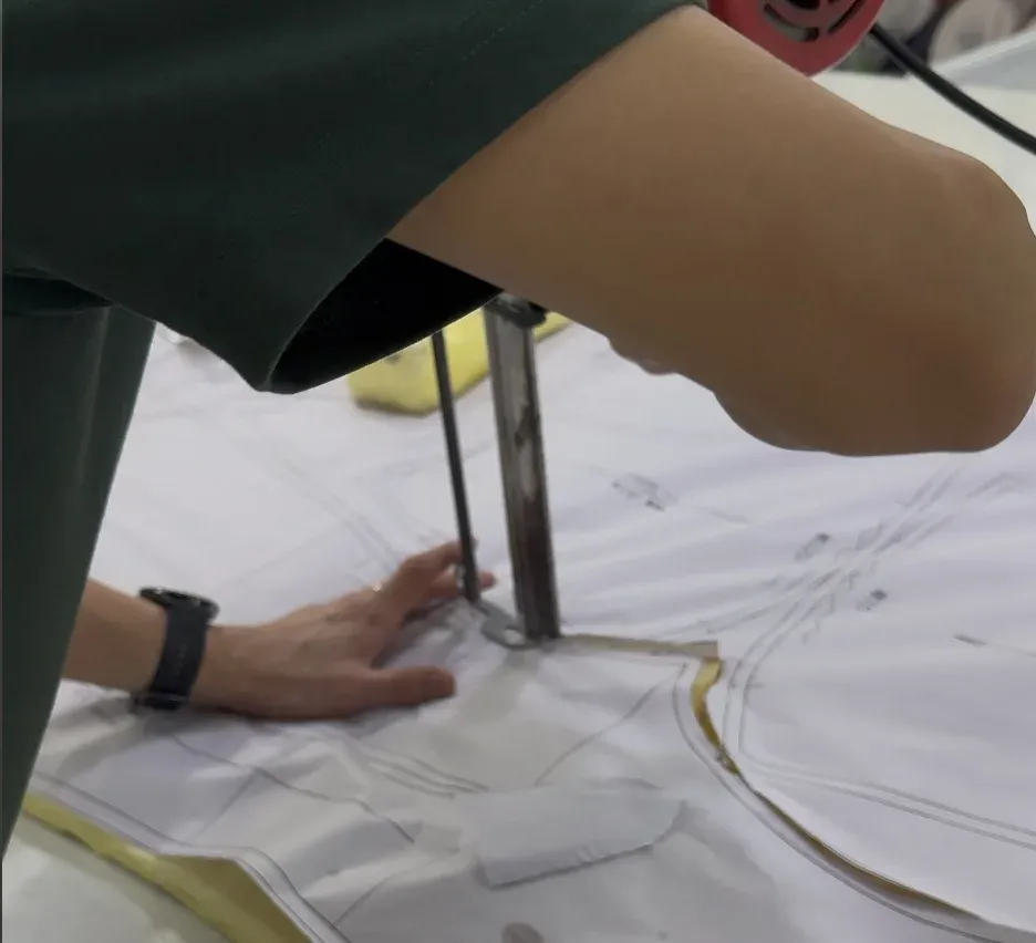 Fabric cutting from printed pattern markers